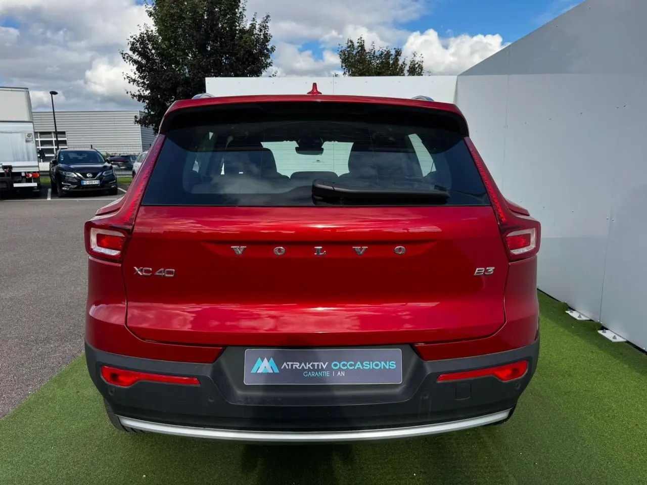 Vue arrière d'un Volvo XC40 B3 rouge Fusion avec feux LED caractéristiques et hayon électrique visible.