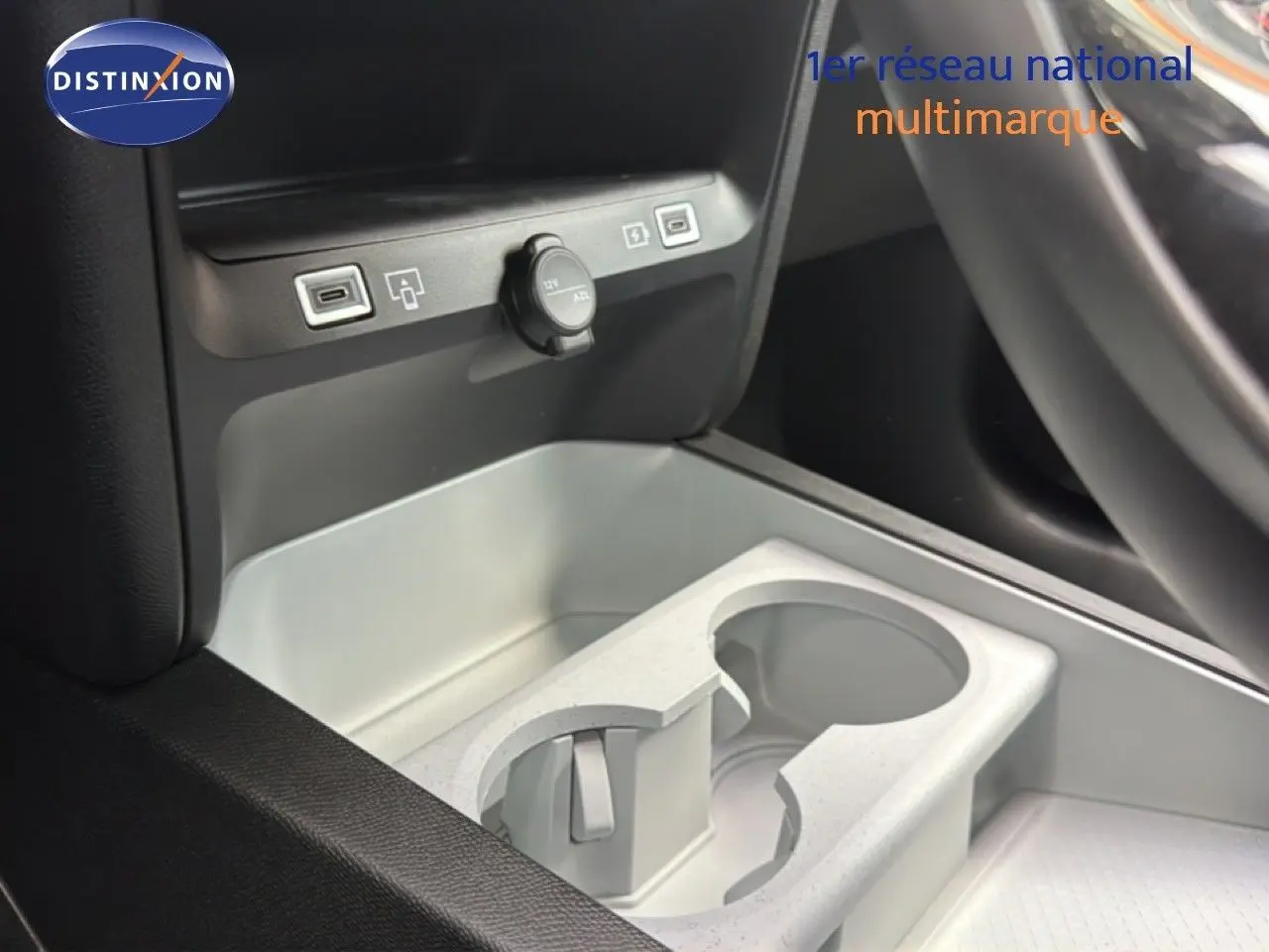 Gros plan sur la console centrale grise platinium du Citroën C5 Aircross Hybrid avec porte-gobelets et prises USB visibles.