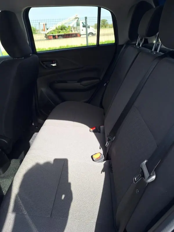 Vue intérieure de la banquette arrière noire de la Suzuki Swift 2025, avec ceintures et appuis-tête visibles.