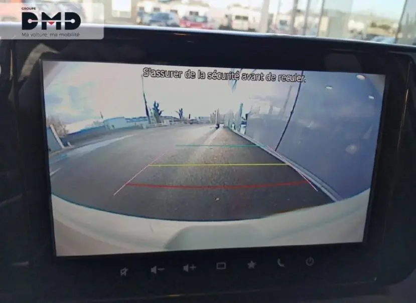 Vue de la caméra de recul d'une Suzuki Swift 1.2 Privilège Hybrid jaune Cool, affichant l'arrière et l'environnement proche.