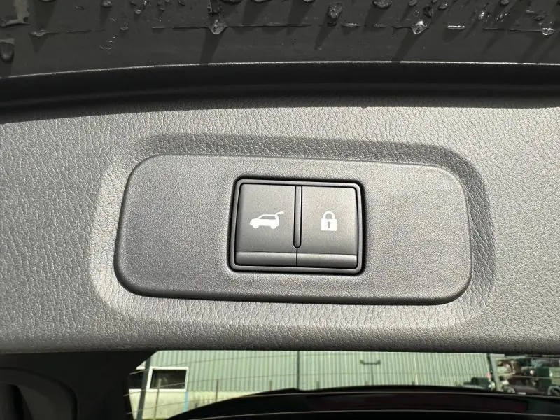 Boutons de commande d'ouverture et de verrouillage du coffre sur le hayon intérieur d'un Nissan Qashqai Hybrid e-POWER 2025 noir.