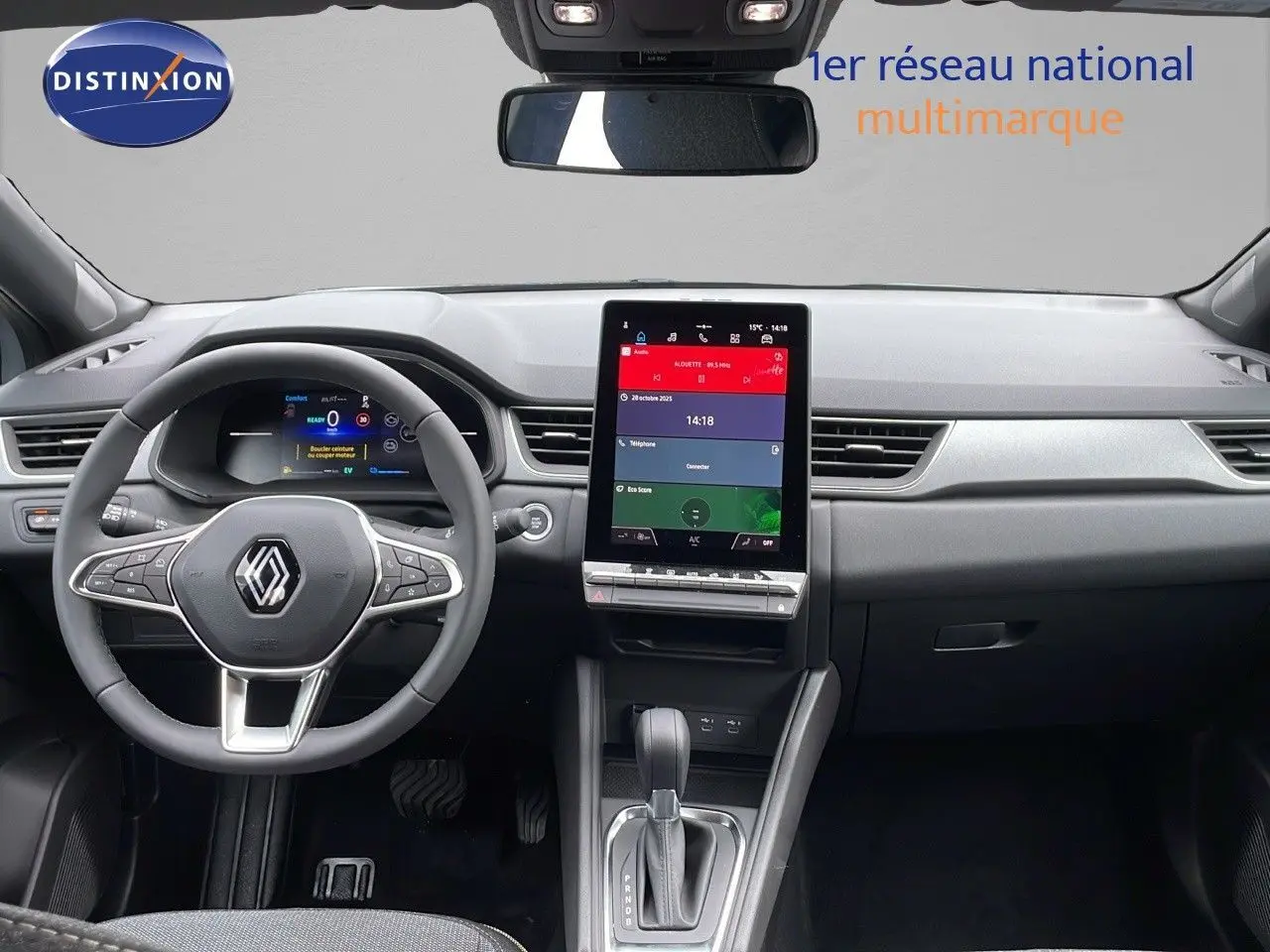 Vue intérieure du tableau de bord et volant du Renault Captur E-Tech gris rafale avec écran tactile vertical et boîte automatique.