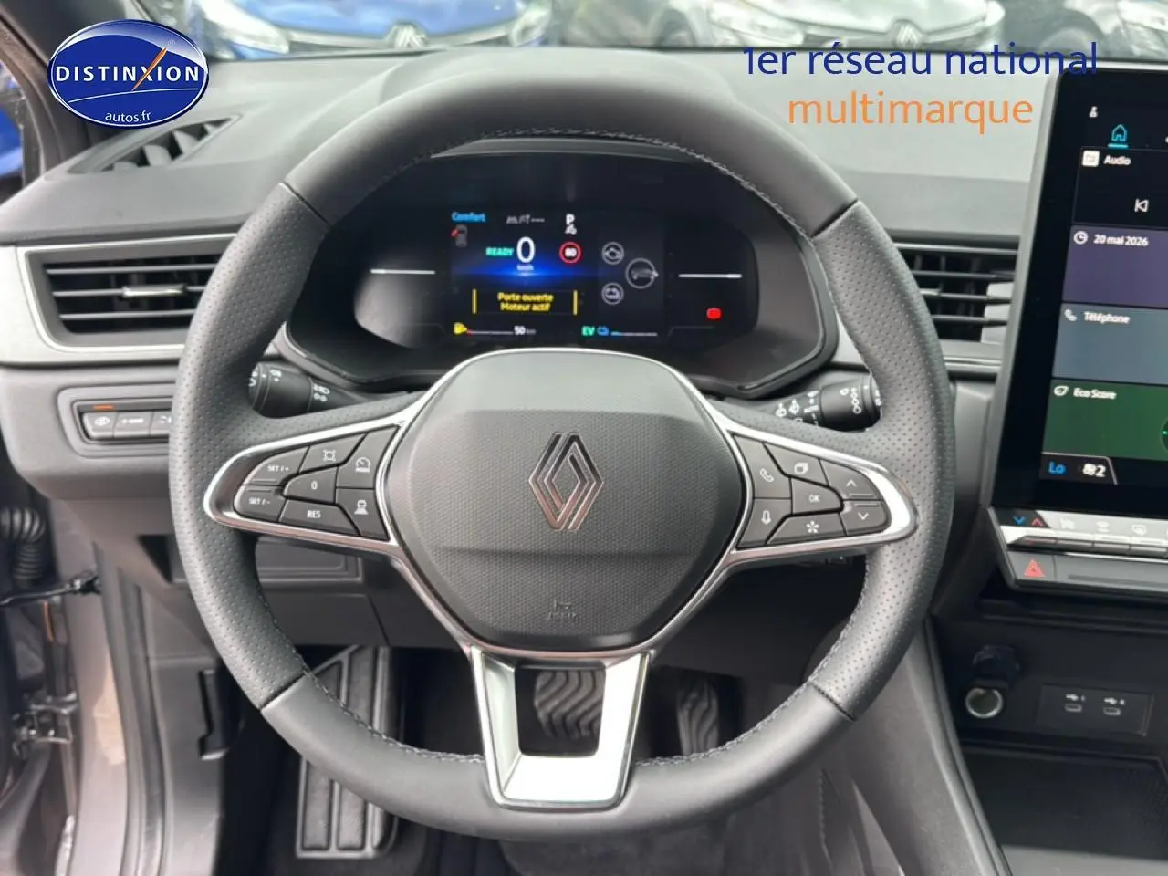 Vue intérieure centrée sur le volant noir perforé du Renault Captur 2026 avec tableau de bord numérique et écran tactile.