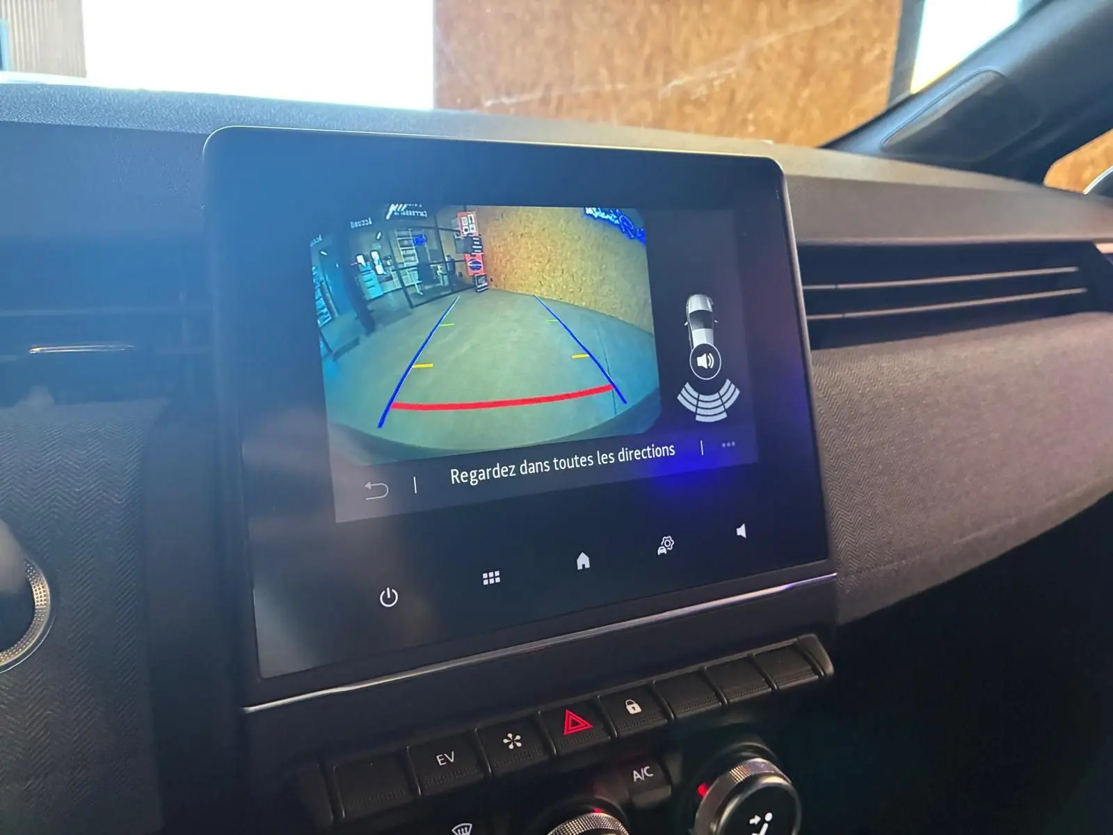 Écran tactile central affichant la caméra de recul dans l’habitacle gris-noir de la Renault Clio hybride 2025.