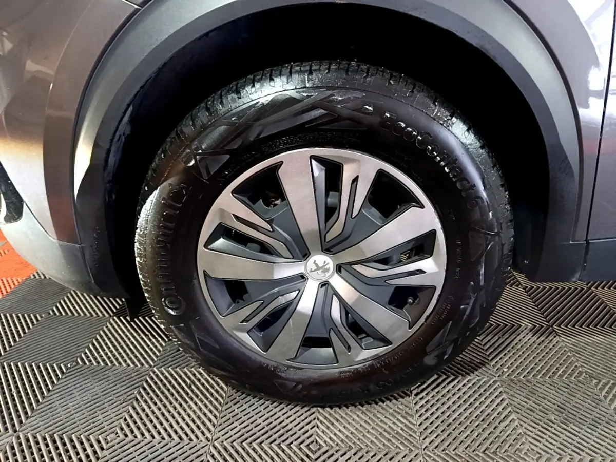 Gros plan sur la roue avant gauche gris clair du Peugeot 2008 avec jante alliage et pneu Continental.