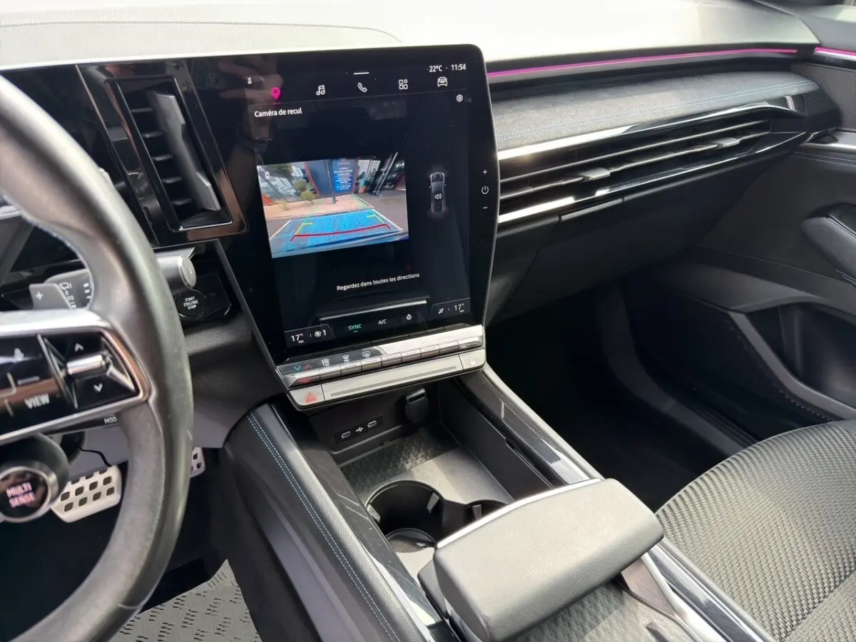 Vue intérieure côté conducteur du Renault Espace 2024 gris foncé, avec grand écran tactile central et volant multifonctions en cuir.