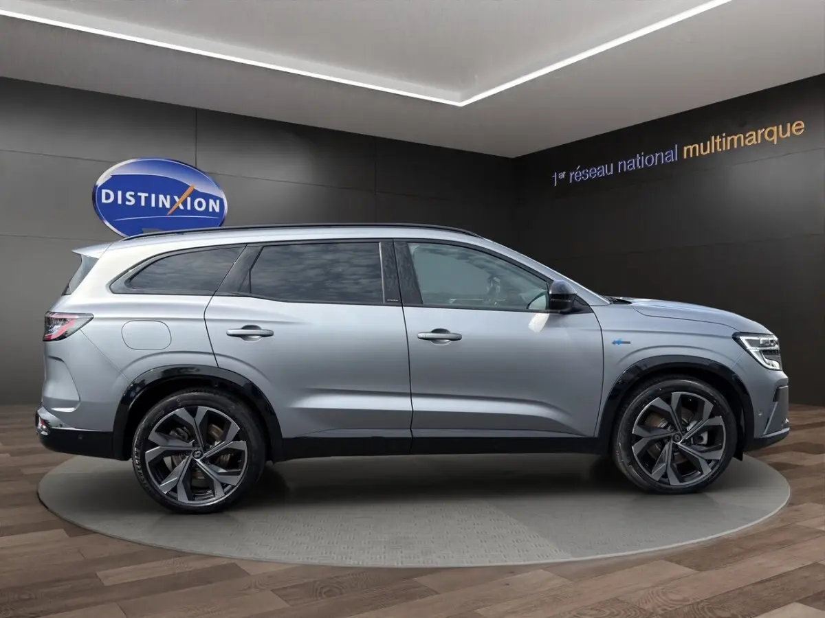 Vue de profil côté gauche d'un Renault Espace gris foncé esprit Alpine E-Tech hybride avec jantes noires distinctives.
