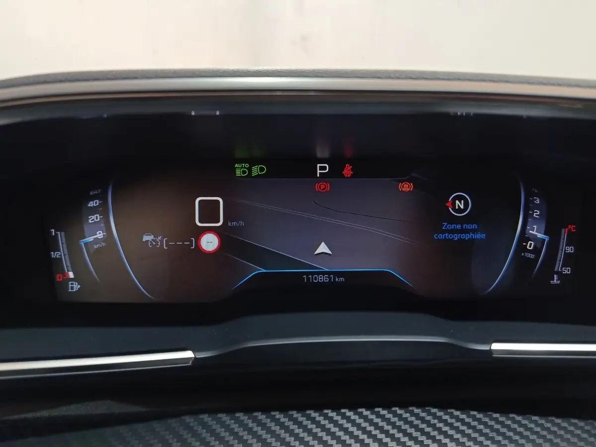 Tableau de bord numérique de Peugeot 508 gris clair, affichage multifonctions avec indicateurs de vitesse et navigation.