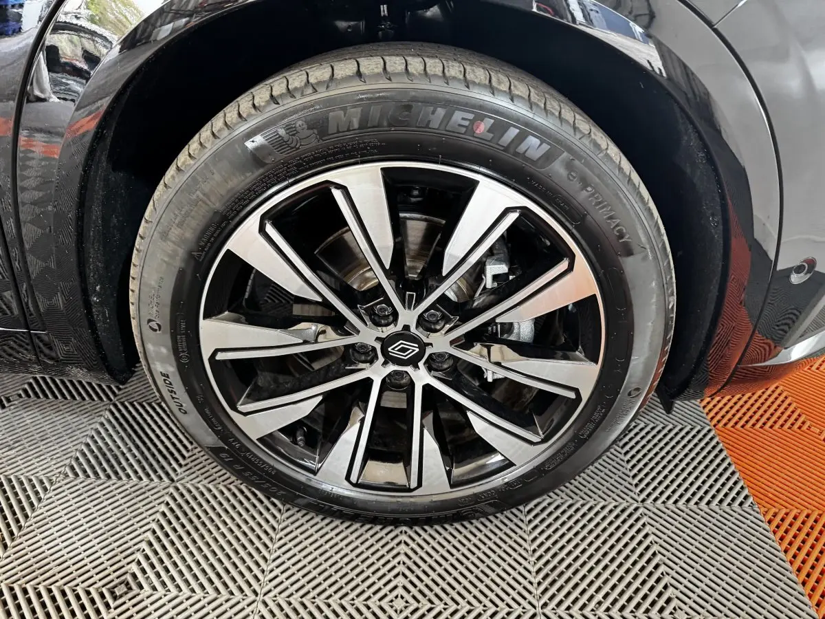 Gros plan sur la roue avant droite noire avec jante alliage bicolore du Renault Espace techno 7PL E-Tech 2025.