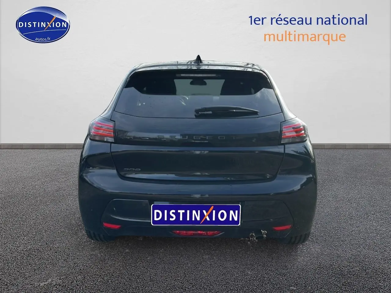 Vue arrière d'une Peugeot 208 noire 2024 avec feux LED et lunette arrière surteintée sur sol goudronné.