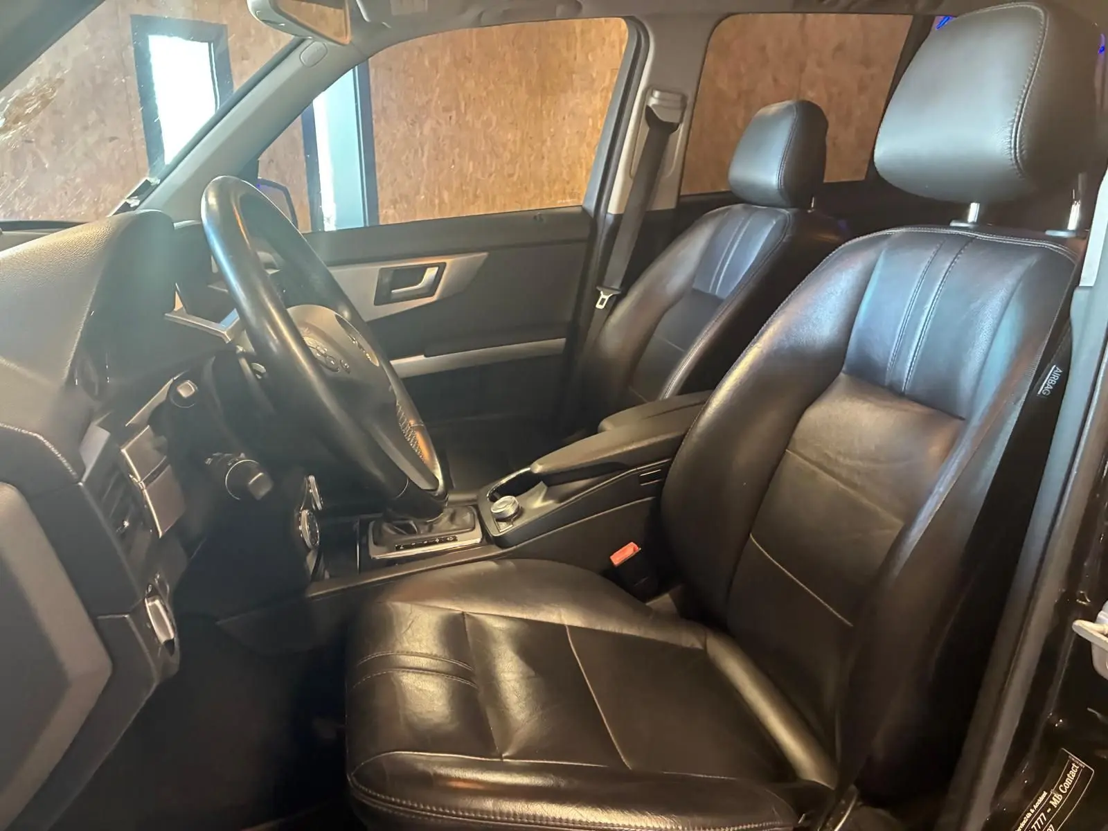 Intérieur noir cuir de la Mercedes GLK 220 CDI, vue côté conducteur montrant sièges et volant.