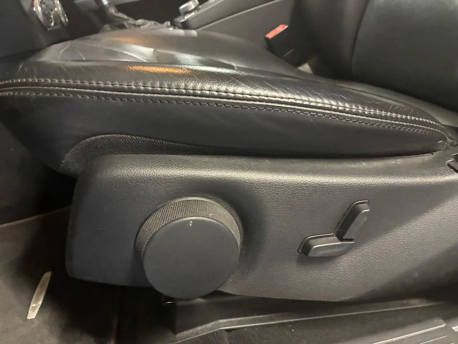 Gros plan sur les commandes de réglage électrique du siège en cuir noir côté conducteur du Mercedes GLK 220 CDI 2012.