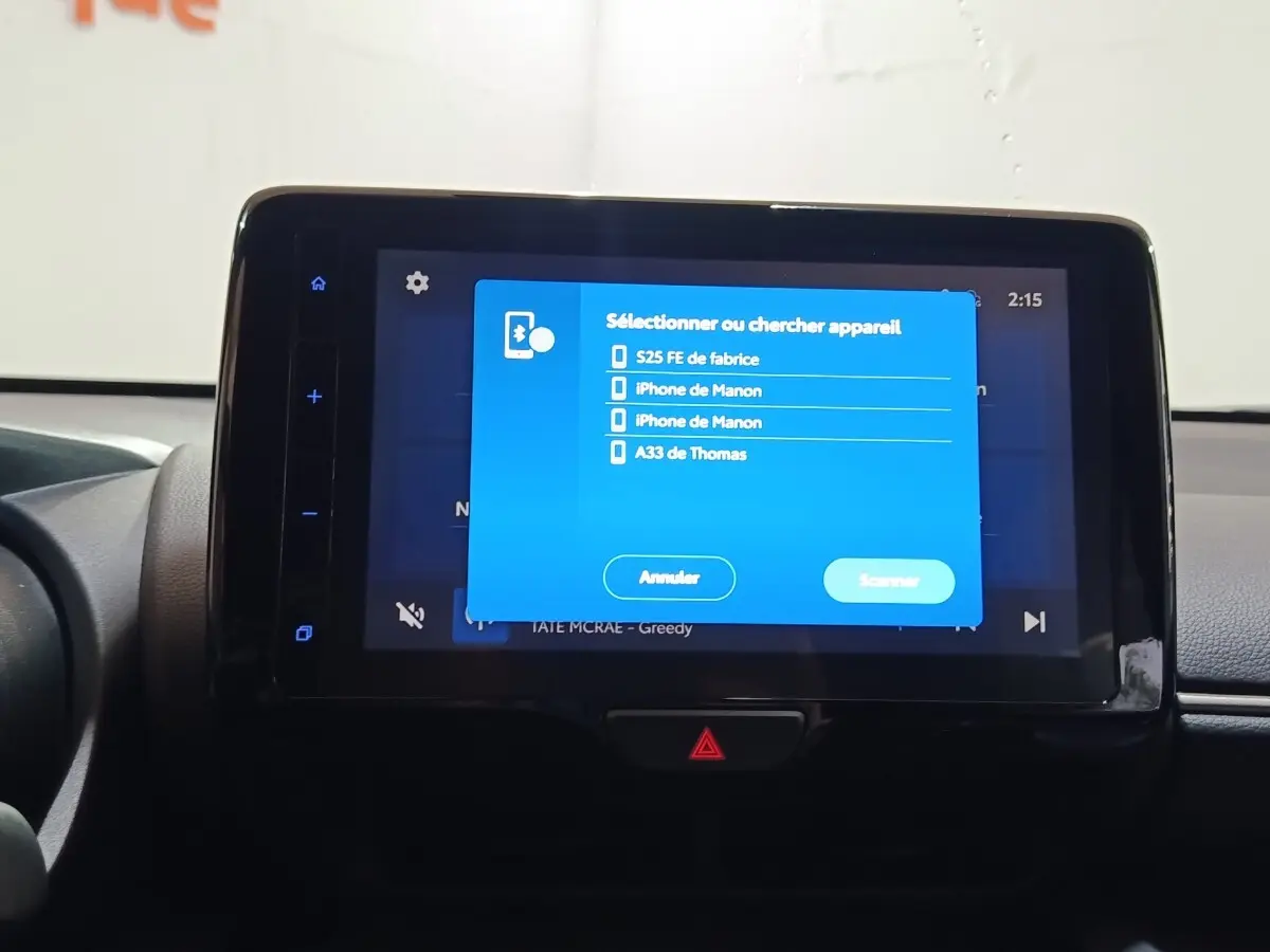 Écran tactile central allumé dans l’habitacle d’une Toyota Yaris Cross 1.5 Hybrid gris foncé, vue de face.