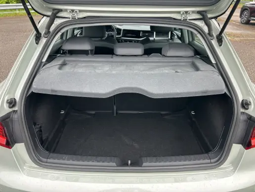 Coffre ouvert d’une Audi A1 Sportback gris 2025, vue arrière montrant l’espace de chargement et l’intérieur partiel.