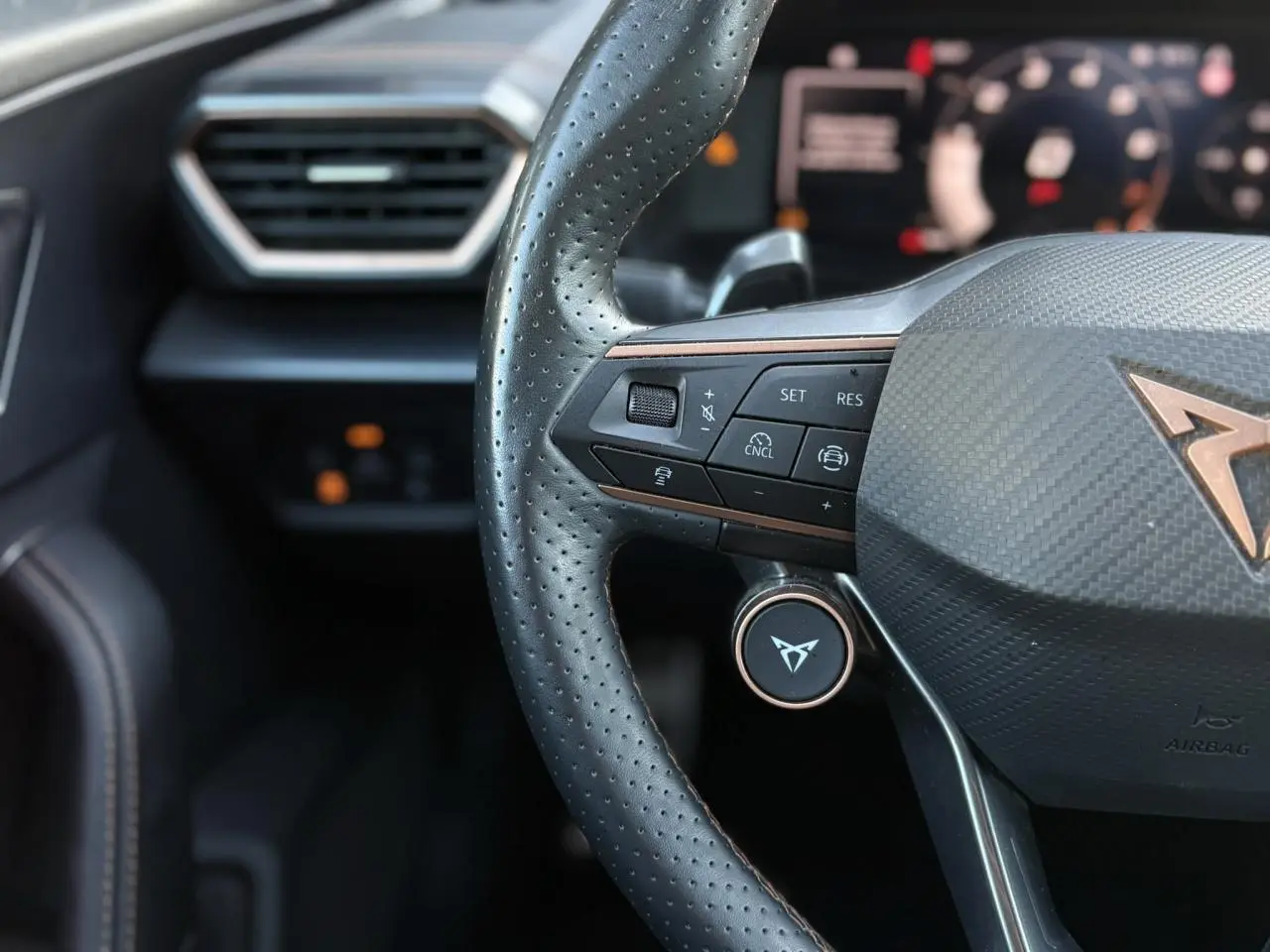 Gros plan sur les commandes électriques du siège conducteur en suédine noir asphalte du CUPRA Formentor gris magnétique.