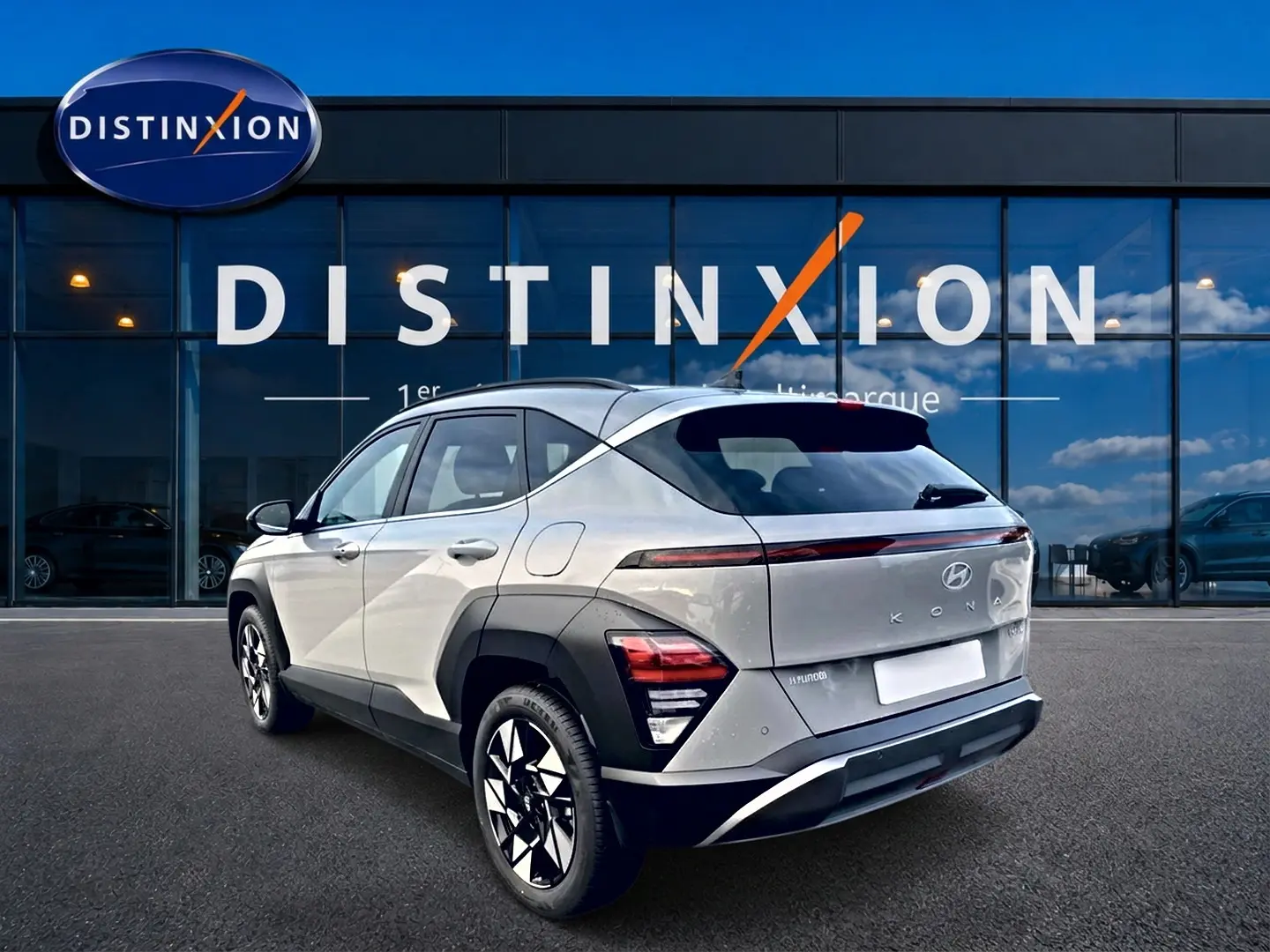 Vue 3/4 arrière droite d'un Hyundai Kona gris 2025 avec feux arrière LED et jantes alliage noires et argent.