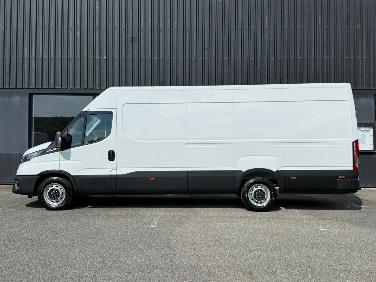 Profil droit d’un utilitaire Iveco Daily blanc, version 35S18 3.0 V16 Himatic 2026, avec bas de caisse noir et jantes acier.