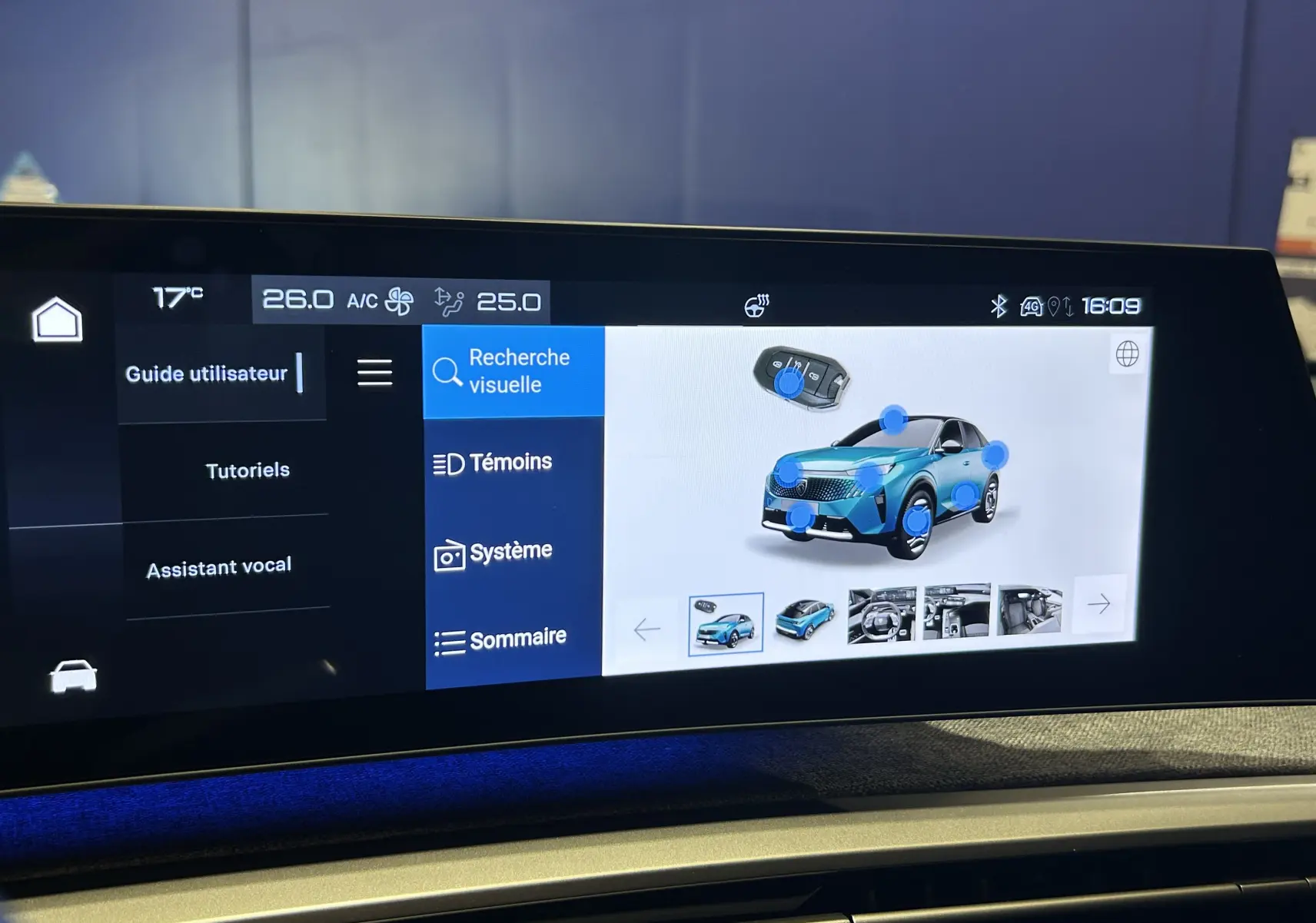 Écran tactile intérieur montrant l'interface du guide utilisateur du Peugeot 3008 hybride gris Artense, vue de face.