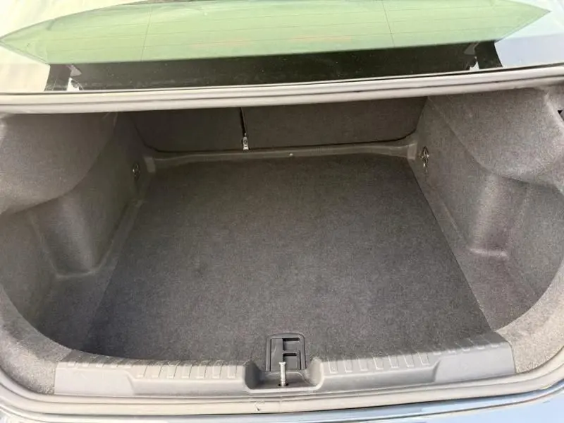 Coffre ouvert vu de l'arrière d'une Audi A3 Berline gris foncé métal 2022, espace de chargement vide et propre.