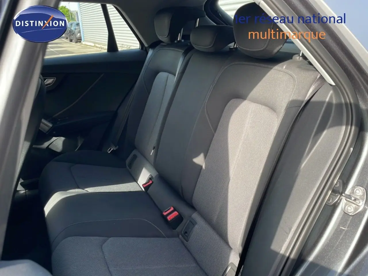 Vue intérieure côté droit des sièges arrière en tissu gris d'un Audi Q2 30 TDI S-Line 2025 couleur gris Manhattan métal.