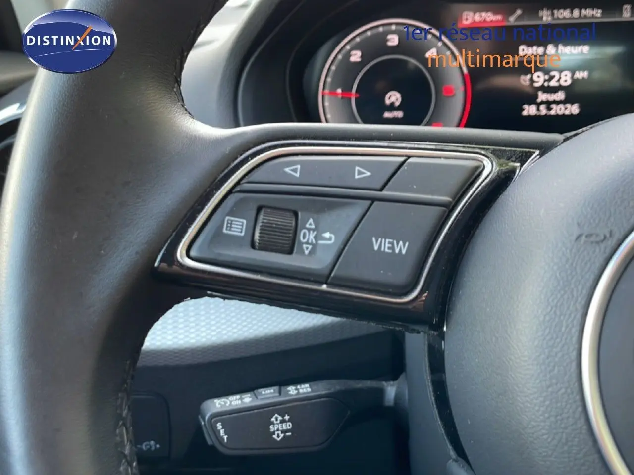 Gros plan sur le volant d’un Audi Q2 30 TDI S-Line 2025, avec commandes multifonctions et tableau de bord numérique.