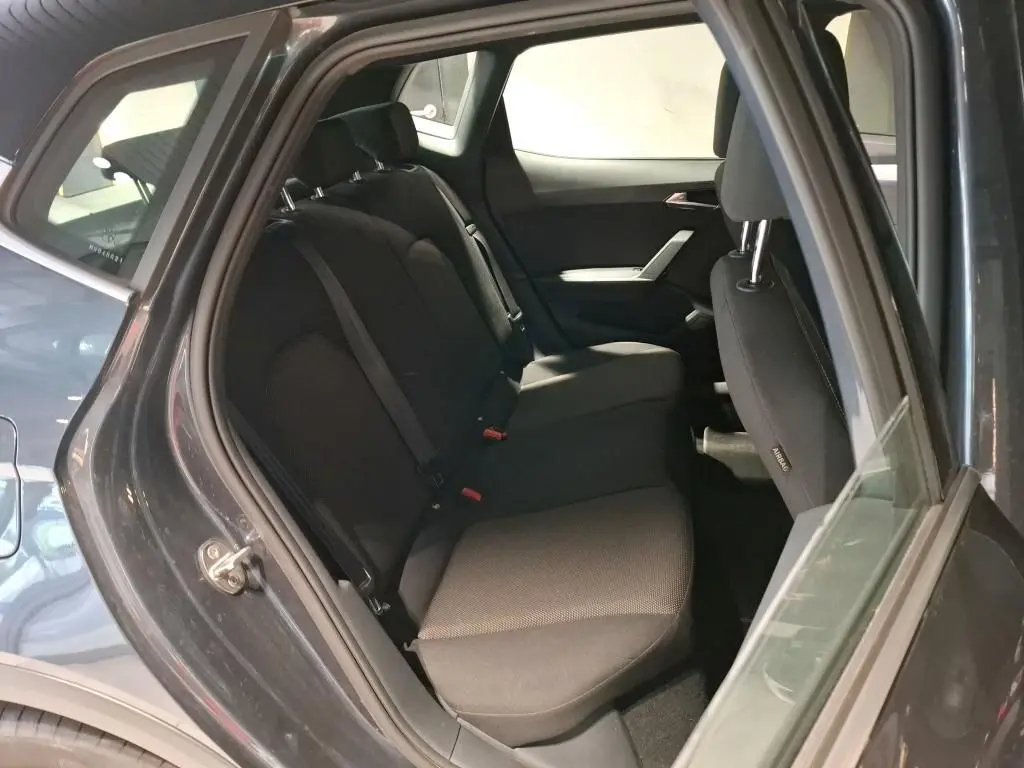 Vue intérieure côté gauche montrant les sièges arrière noirs du SEAT Arona gris foncé 2021, version Xcellence.