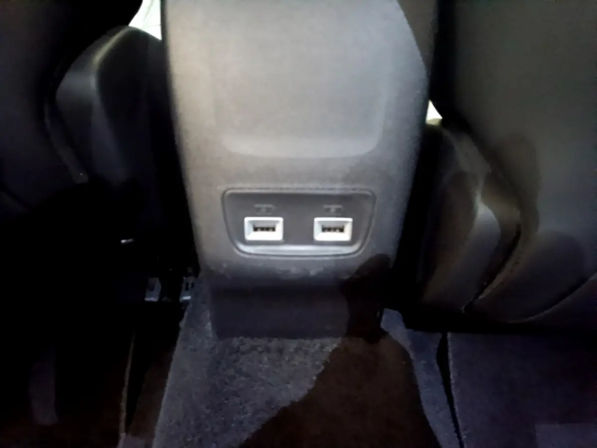 Prise USB double vue en gros plan à l'arrière du siège central d'un Peugeot 2008 gris clair 2021.