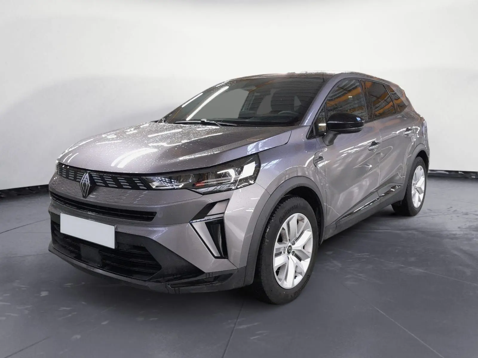 Renault Symbioz E-Tech Full Hybrid gris cassiopée, vue 3/4 avant droit, avec calandre moderne et jantes blanches.