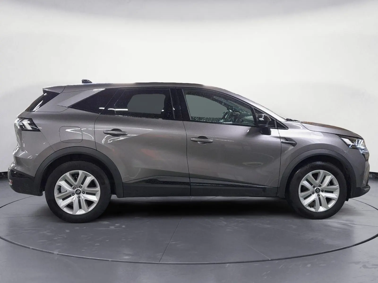 Profil côté gauche du Renault SYMBIOZ E-TECH Full Hybrid 145 gris Cassiopée, SUV hybride 2025 avec lignes épurées et jantes argentées.