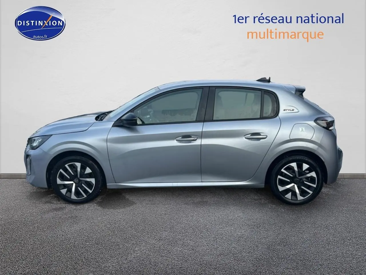 Profil côté gauche d'une Peugeot 208 1.2 100 Style gris Artense avec jantes noires et logo Style sur l'aile arrière.