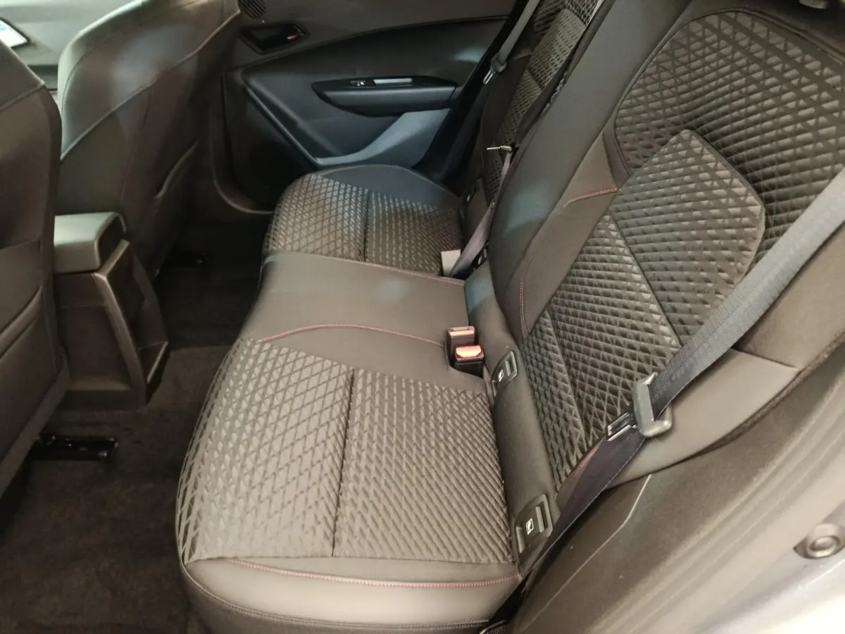 Vue intérieure côté droit des sièges arrière gris foncé avec surpiqûres rouges de la Renault Clio Techno TCe 115 ch 2026.