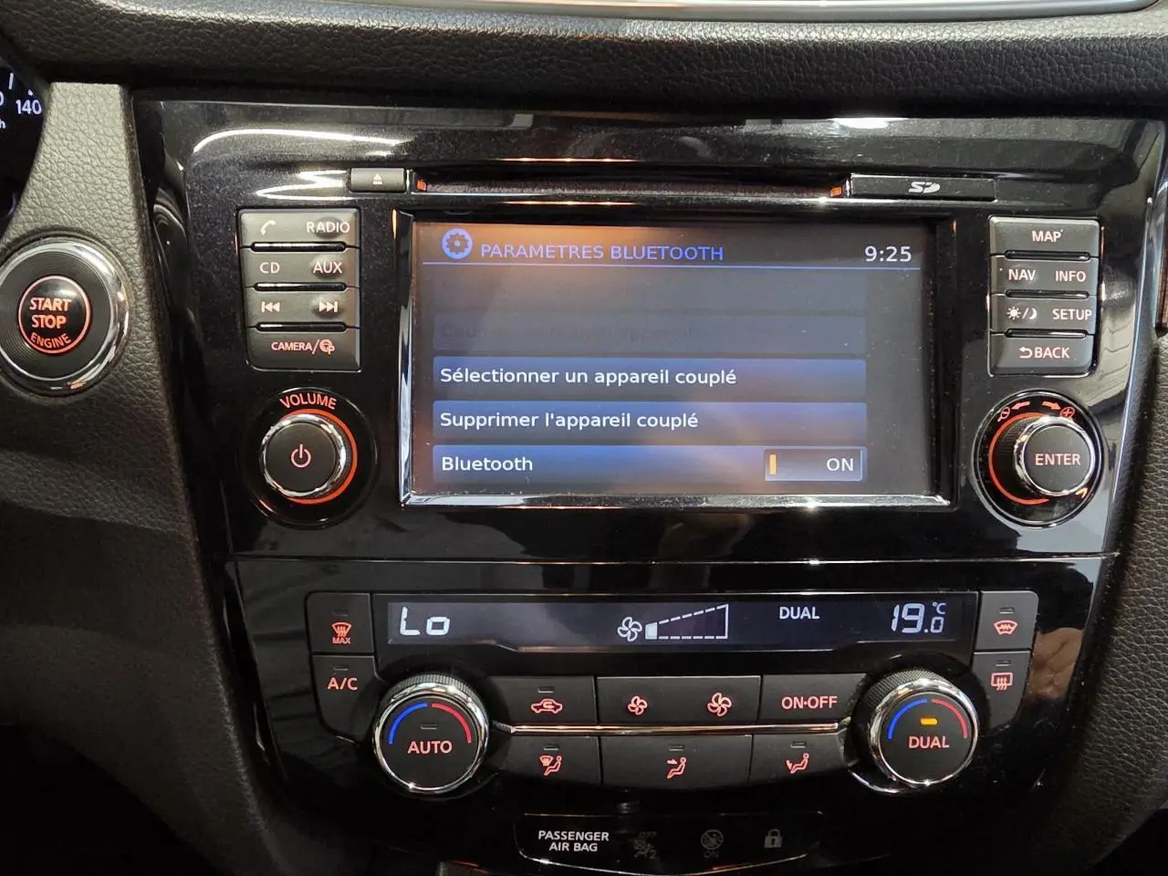 Vue rapprochée de la console centrale noire du Nissan Qashqai 2018 avec écran tactile et commandes climatisation.
