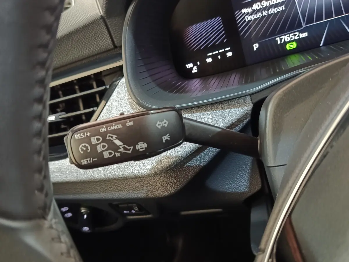 Gros plan sur la commande multifonctions à gauche du volant dans le tableau de bord gris d'une Skoda Scala 2025.
