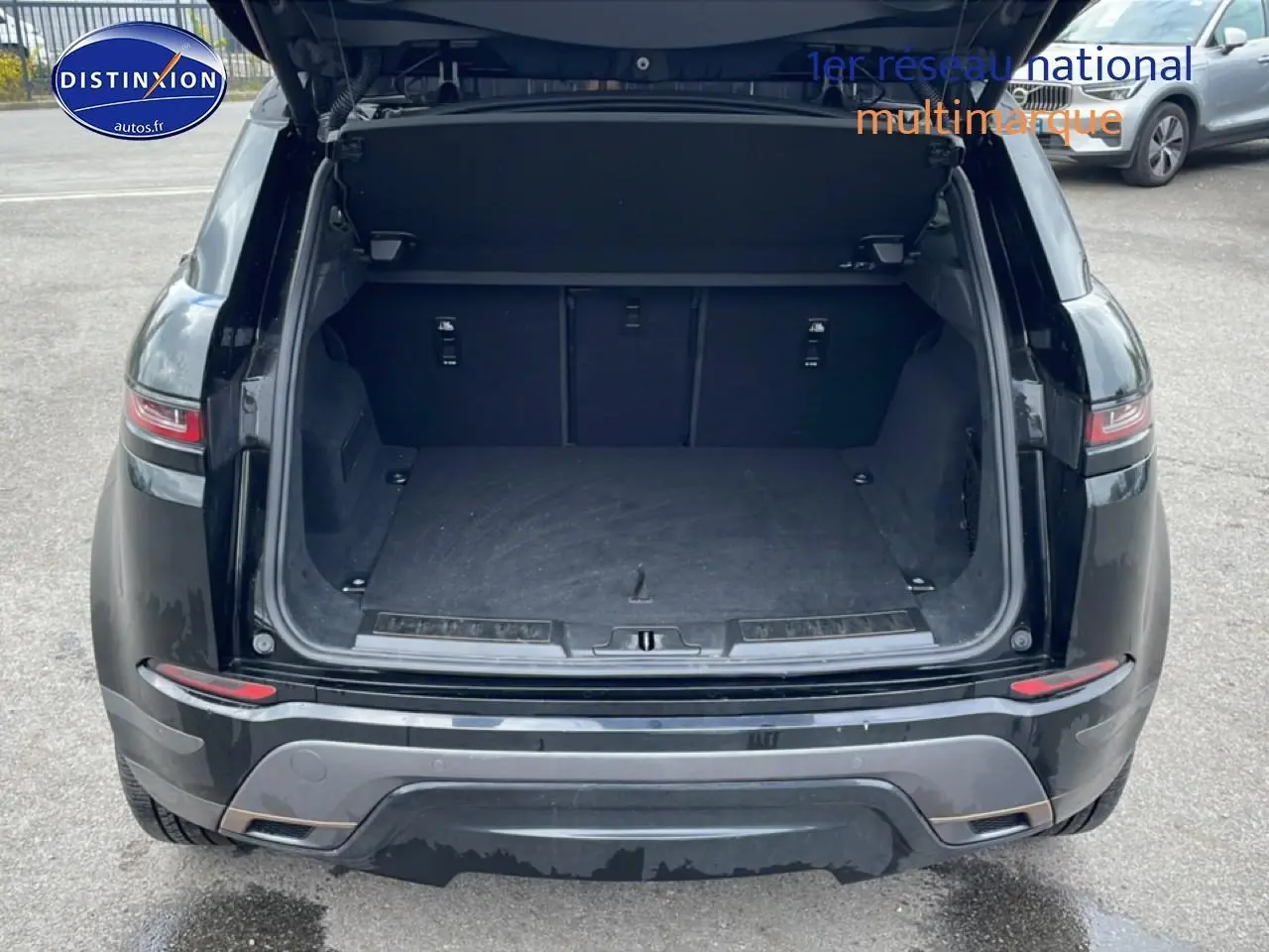 Vue arrière avec coffre ouvert d’un Range Rover Evoque noir 2020, soulignant son espace de chargement vide.