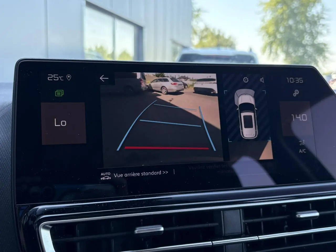Écran tactile intérieur montrant la caméra de recul et l'affichage de la voiture en vue arrière du Citroën C5 Aircross Hybrid bleu Eclipse.