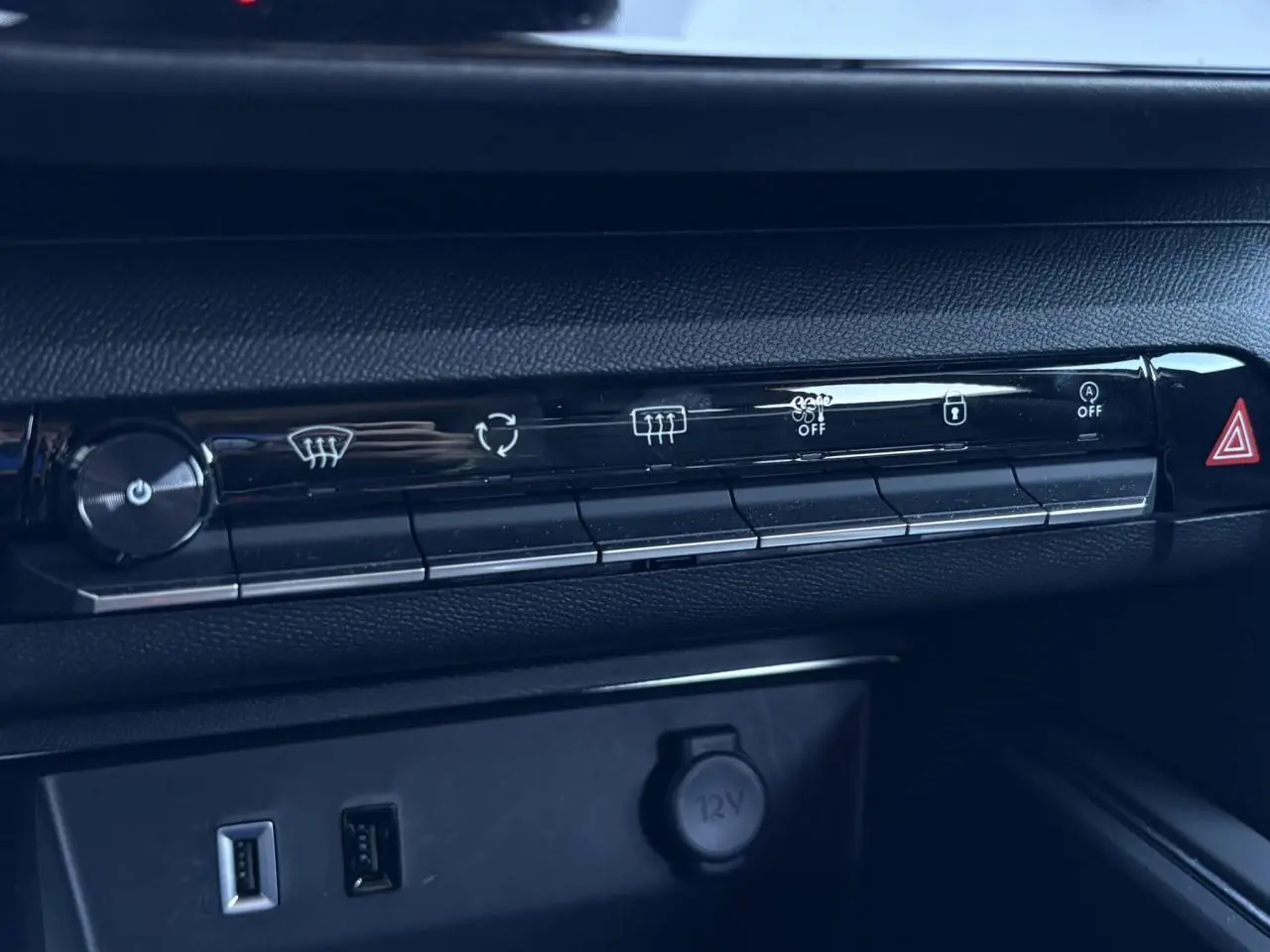 Détail de la console centrale du Citroën C5 Aircross Hybrid 2025, boutons de climatisation et prises USB visibles.