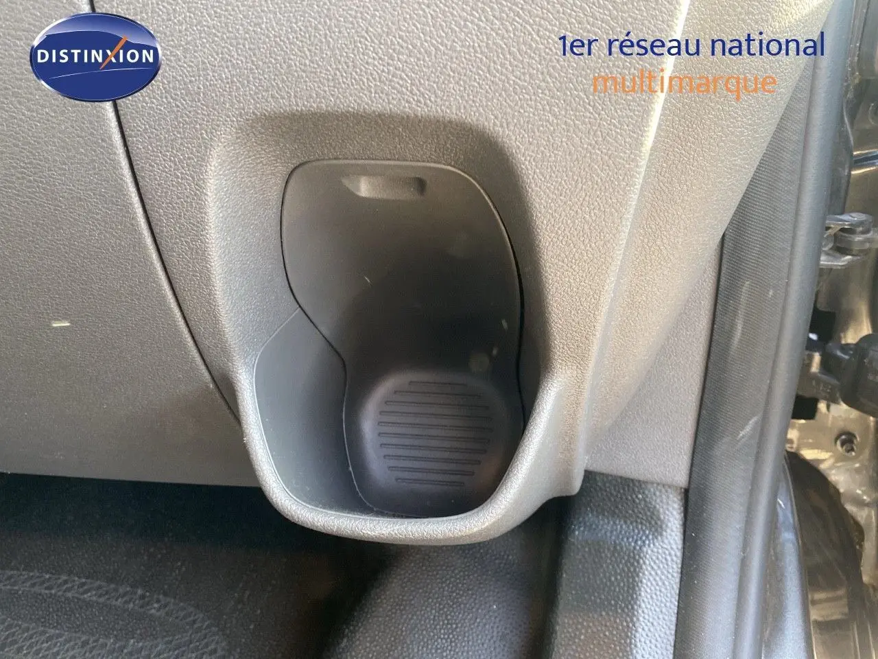 Gros plan sur le porte-gobelet côté passager du Ford Transit Custom gris magnetic 2023, intérieur plastique gris.