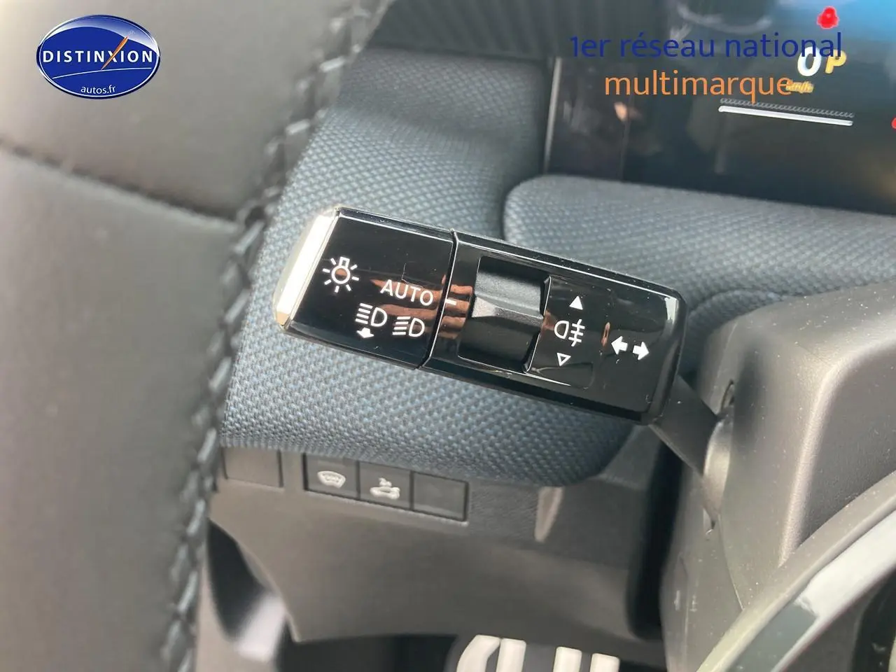 Gros plan sur la commande des phares et clignotants du Citroën C5 Aircross 2026, intérieur tissu bleu.