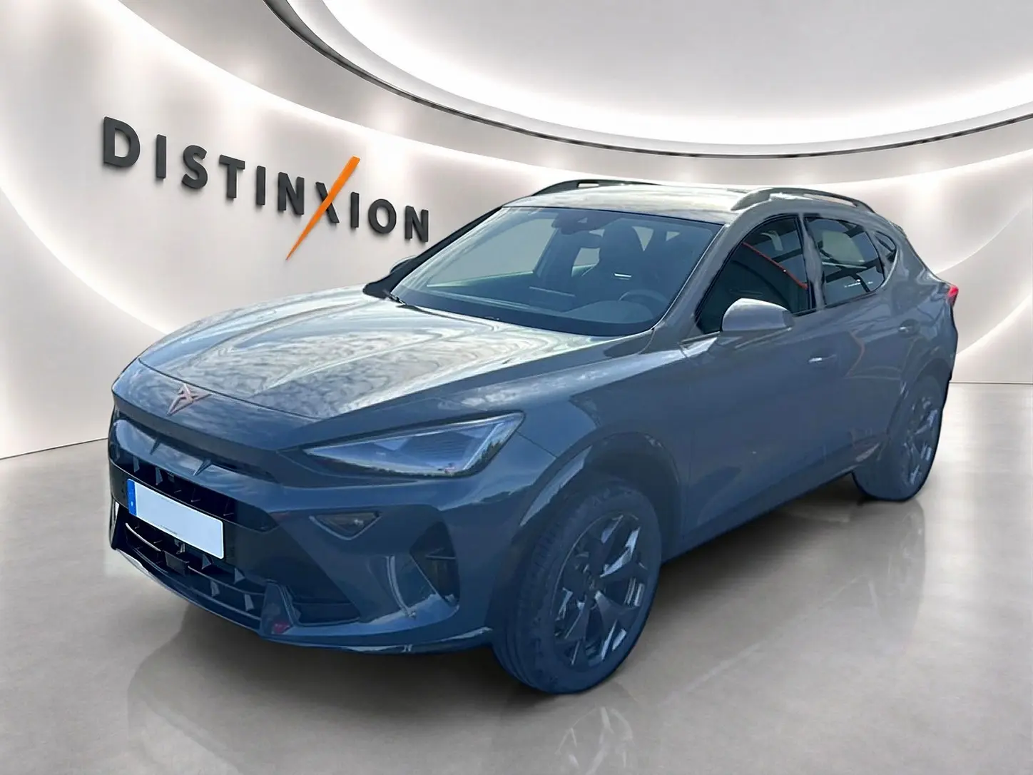 Vue 3/4 avant d'un CUPRA Formentor bleu fjord avec jantes 18 pouces et barres de toit, en intérieur showroom.