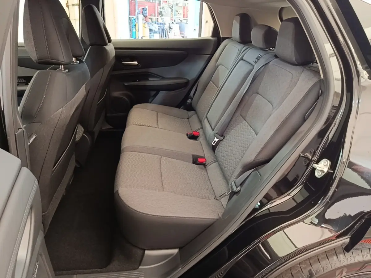 Vue côté droit sur la banquette arrière grise du Nissan Ariya 63kWh noir, montrant les sièges 3 places et ceinture de sécurité.