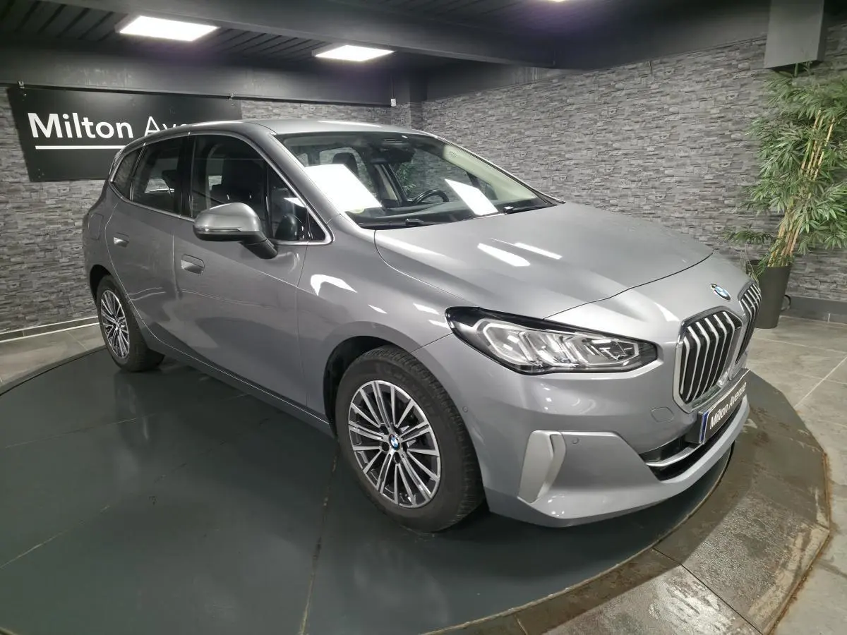 BMW Série 2 218d Active Tourer gris métallisé vue 3/4 avant avec calandre chromée et jantes alliage 17 pouces.