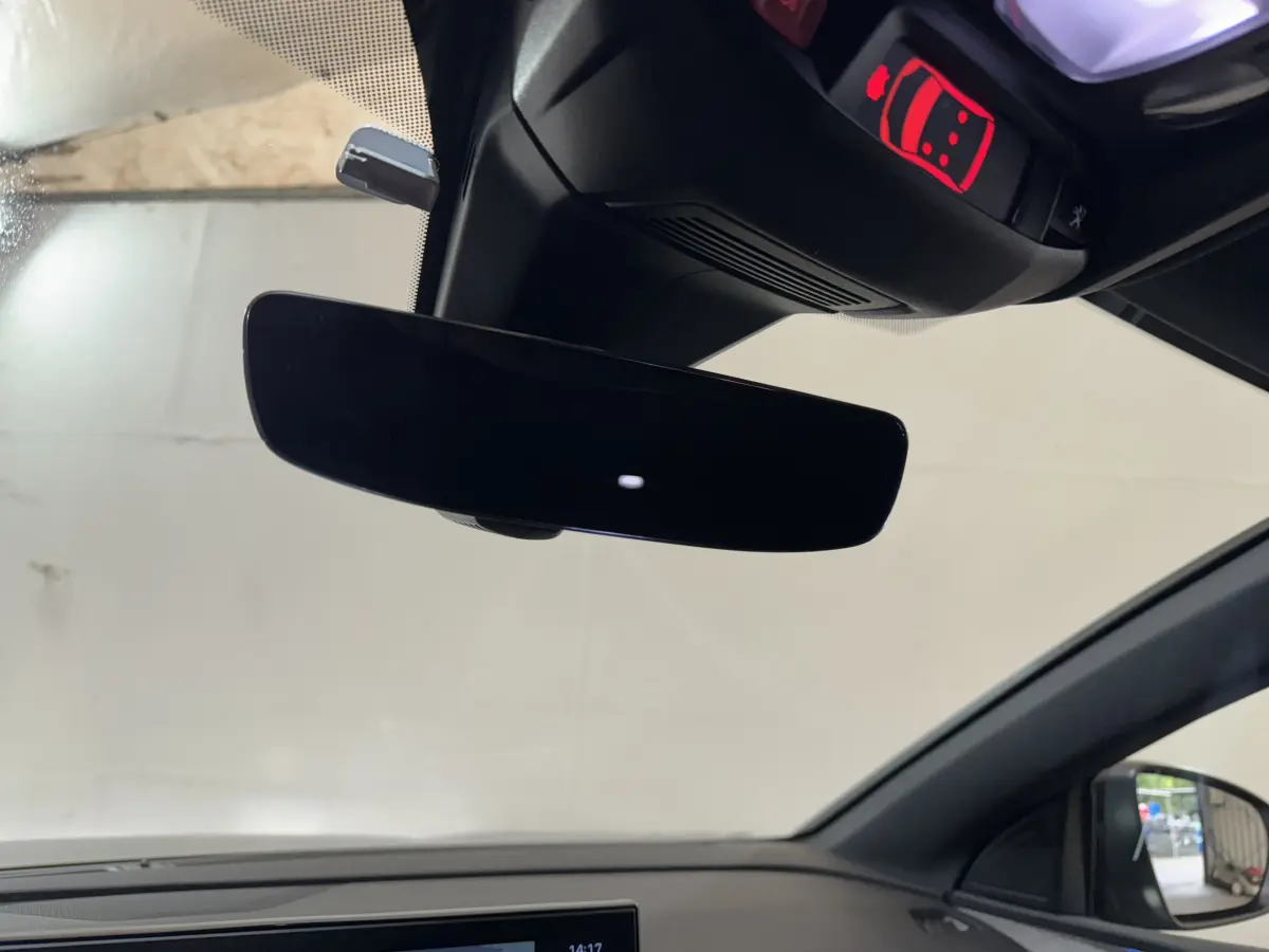 Vue intérieure du rétroviseur central et du plafond noir du Peugeot 3008 gris clair, avec affichage rouge d'alerte au plafond.