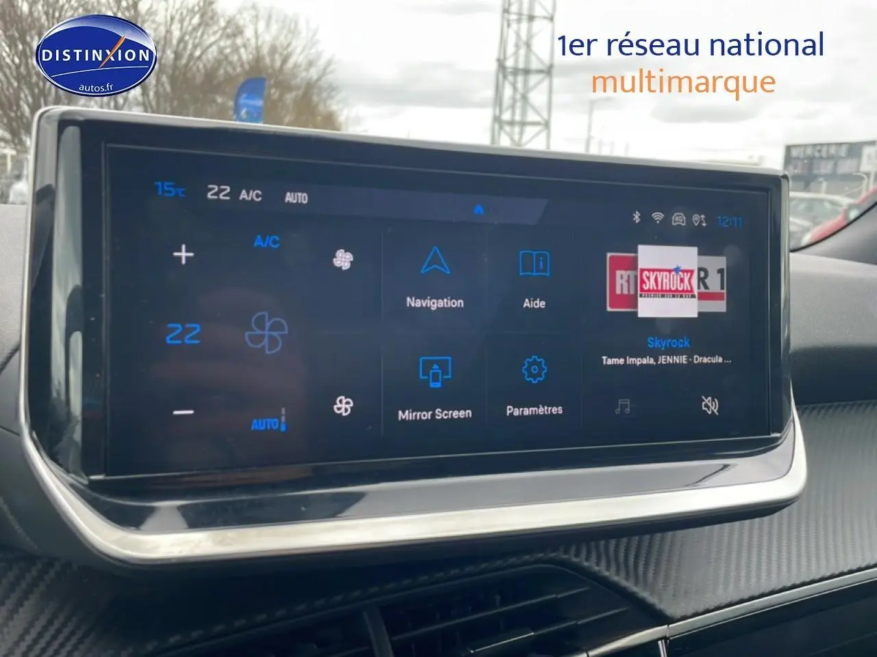 Écran tactile multifonction intérieur du Peugeot 2008 E-136 allure 2025 avec finition carbone et affichage climatisation.