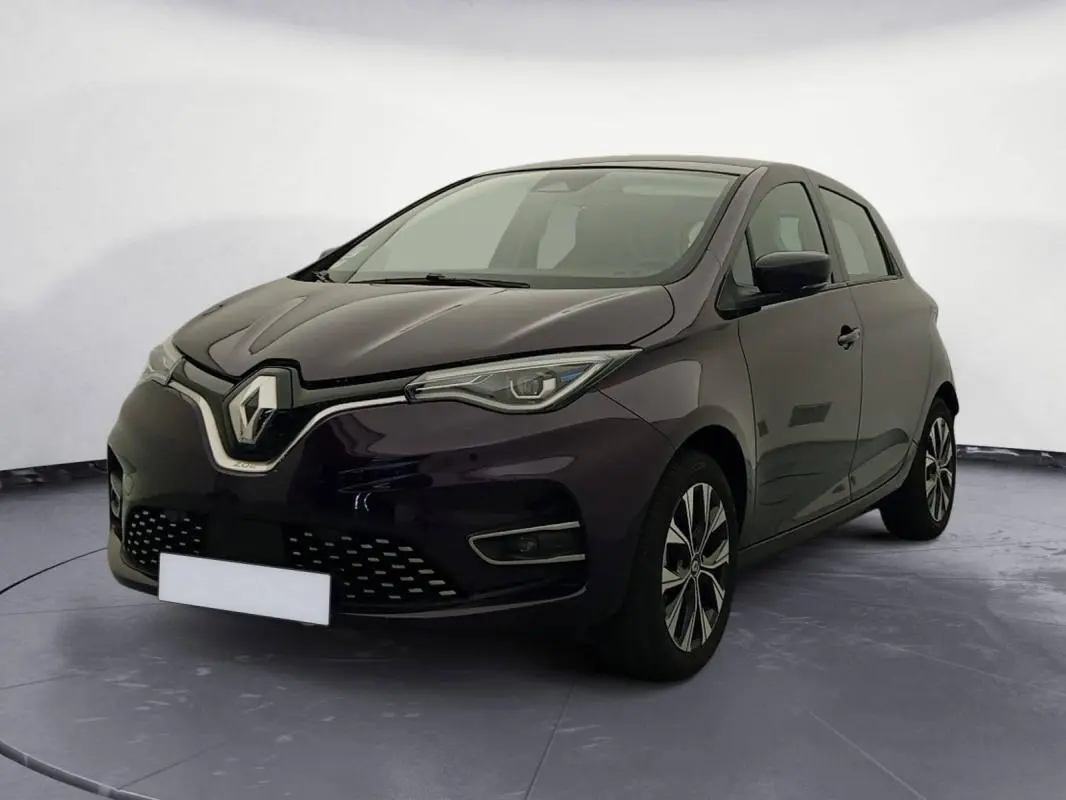 Renault ZOE E-Tech électrique violet en 3/4 avant droit, avec calandre distinctive et jantes stylisées.