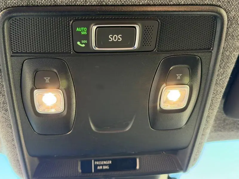 Vue en gros plan du plafonnier intérieur avec éclairages allumés et bouton SOS du Renault Captur 2025 Rouge Flamme/Noir Etoilé.