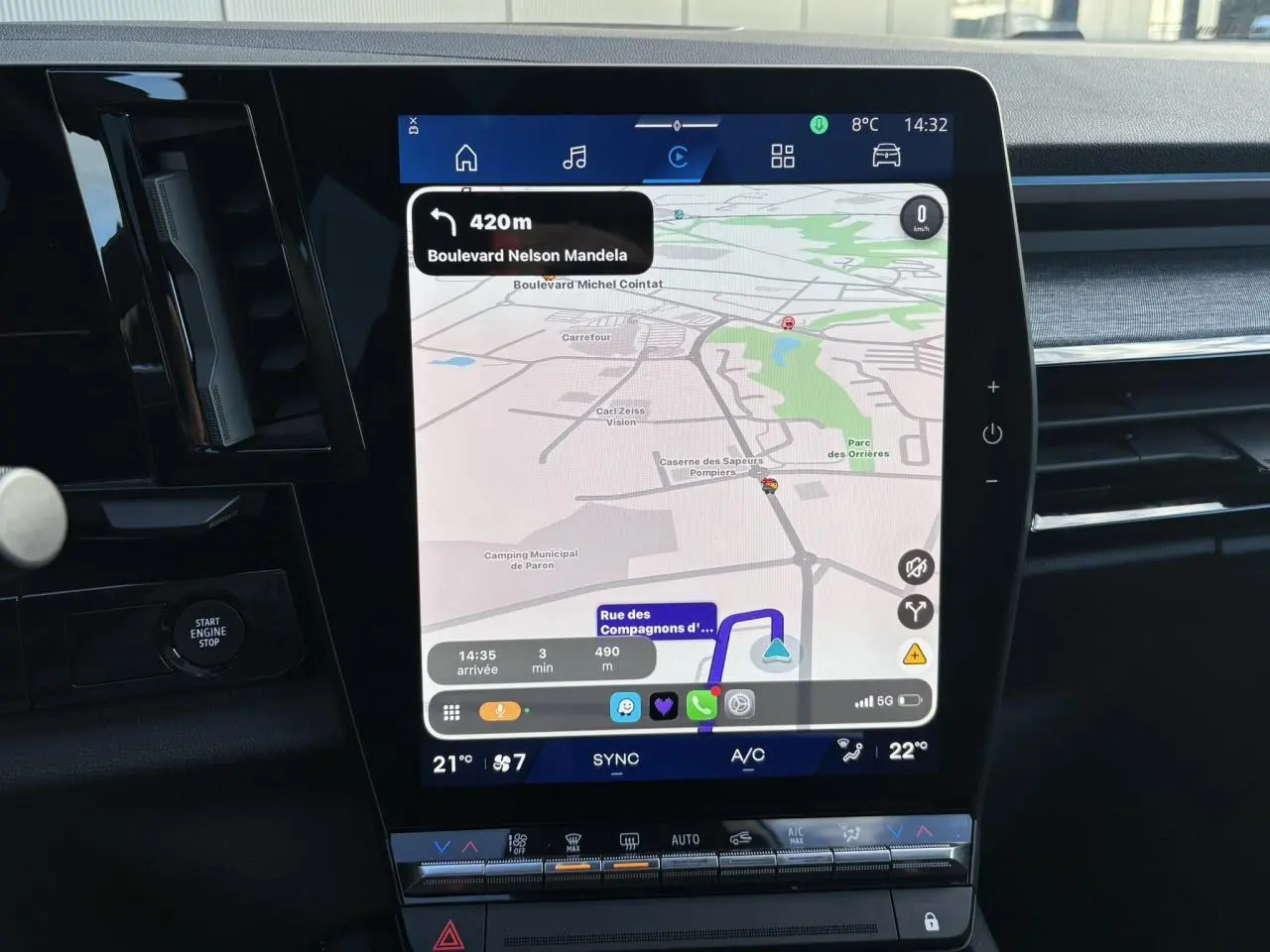 Vue rapprochée de l’écran tactile central du Renault Austral blanc nacré affichant la navigation GPS et les commandes climatisation.