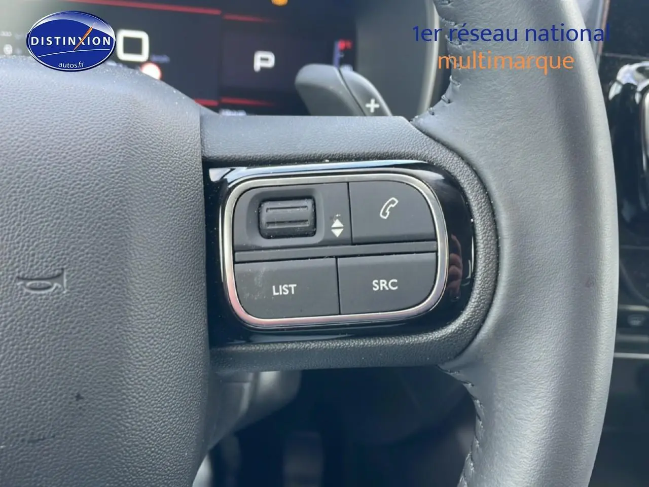 Gros plan sur les commandes gauche du volant cuir noir du Citroën C5 Aircross 2025, avec boutons multifonctions.