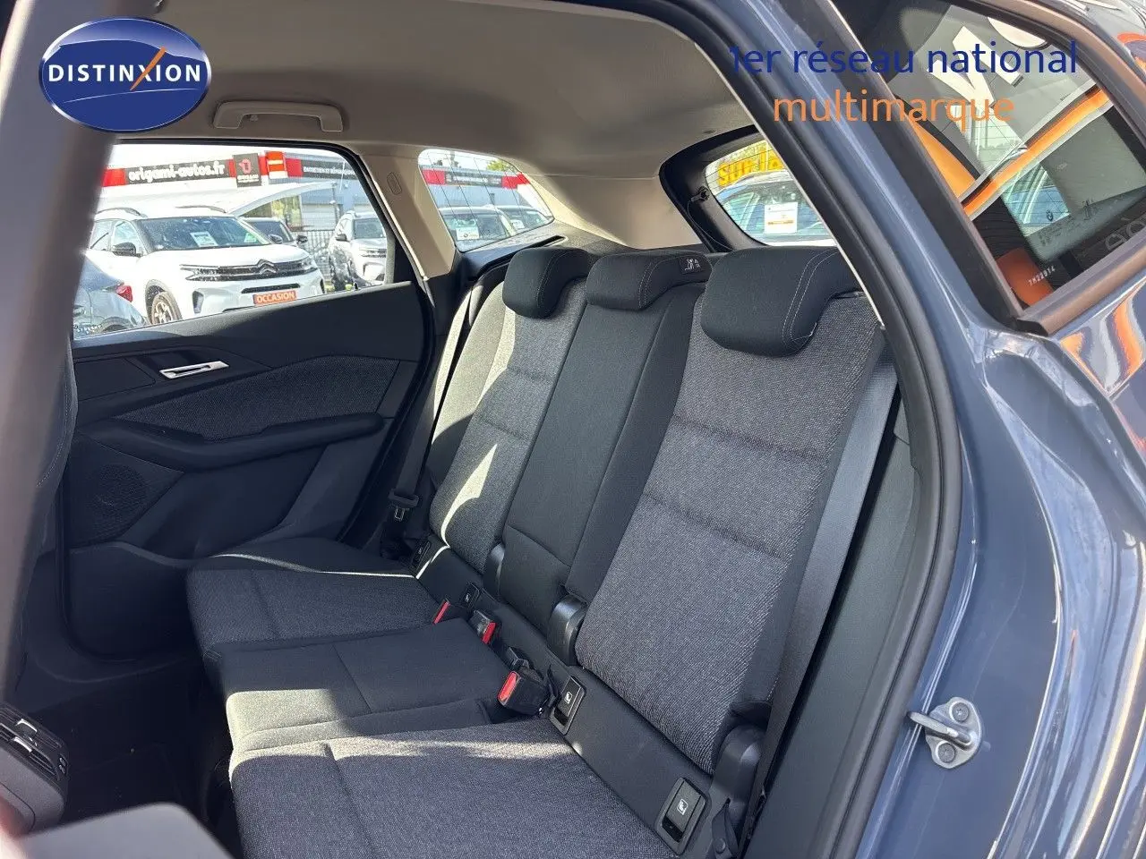 Vue intérieure sur les sièges arrière en tissu gris du BMW Série 2 Active Tourer 218d 2023, porte arrière ouverte côté droit.