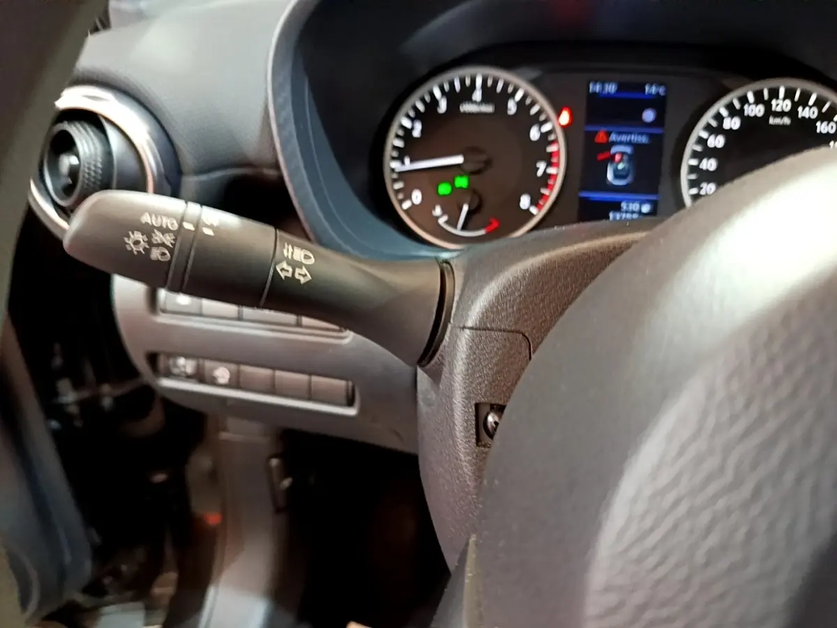 Gros plan sur le volant et le combiné d'instruments du Nissan Juke noir, avec affichage digital et commandes au volant visibles.