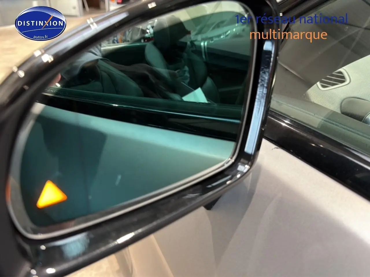 Rétroviseur extérieur droit noir de Mercedes Classe SL 63 AMG avec témoin d'angle mort orange allumé.